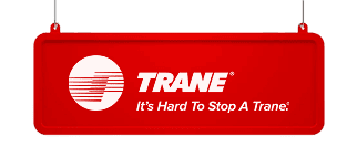 A red sign features the Trane logo, white stylized lines in a circle, with the word TRANE and the slogan Its Hard To Stop A Trane. in white text.